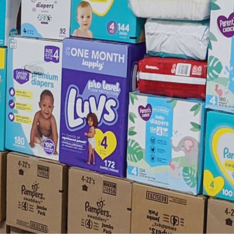 a stack of diaper boxes and packages from various makers