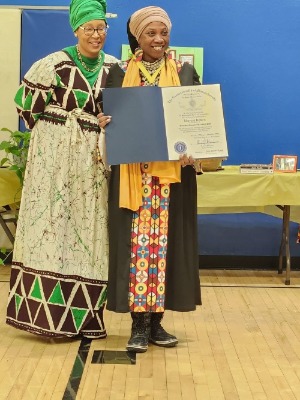 Mpress Bennu accepts an award. 