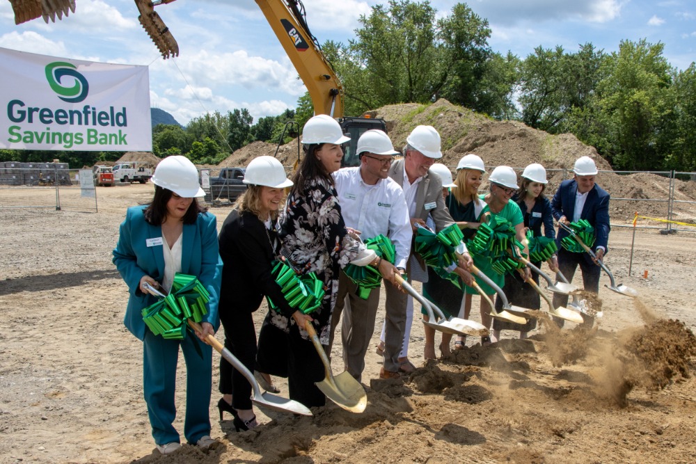 Members of Greenfield Savings Bank's executive staff hold ceremonial shovels at a groundbreaking ceremony