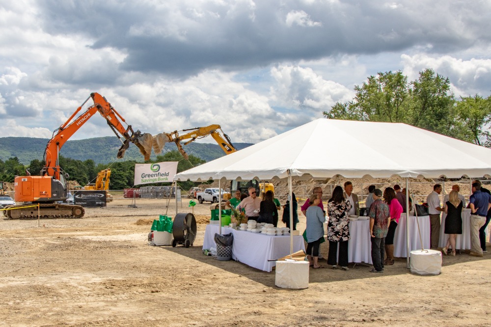 People under a tent attend the groundbreaking of Greenfield Savings Bank's newest branch in Easthampton
