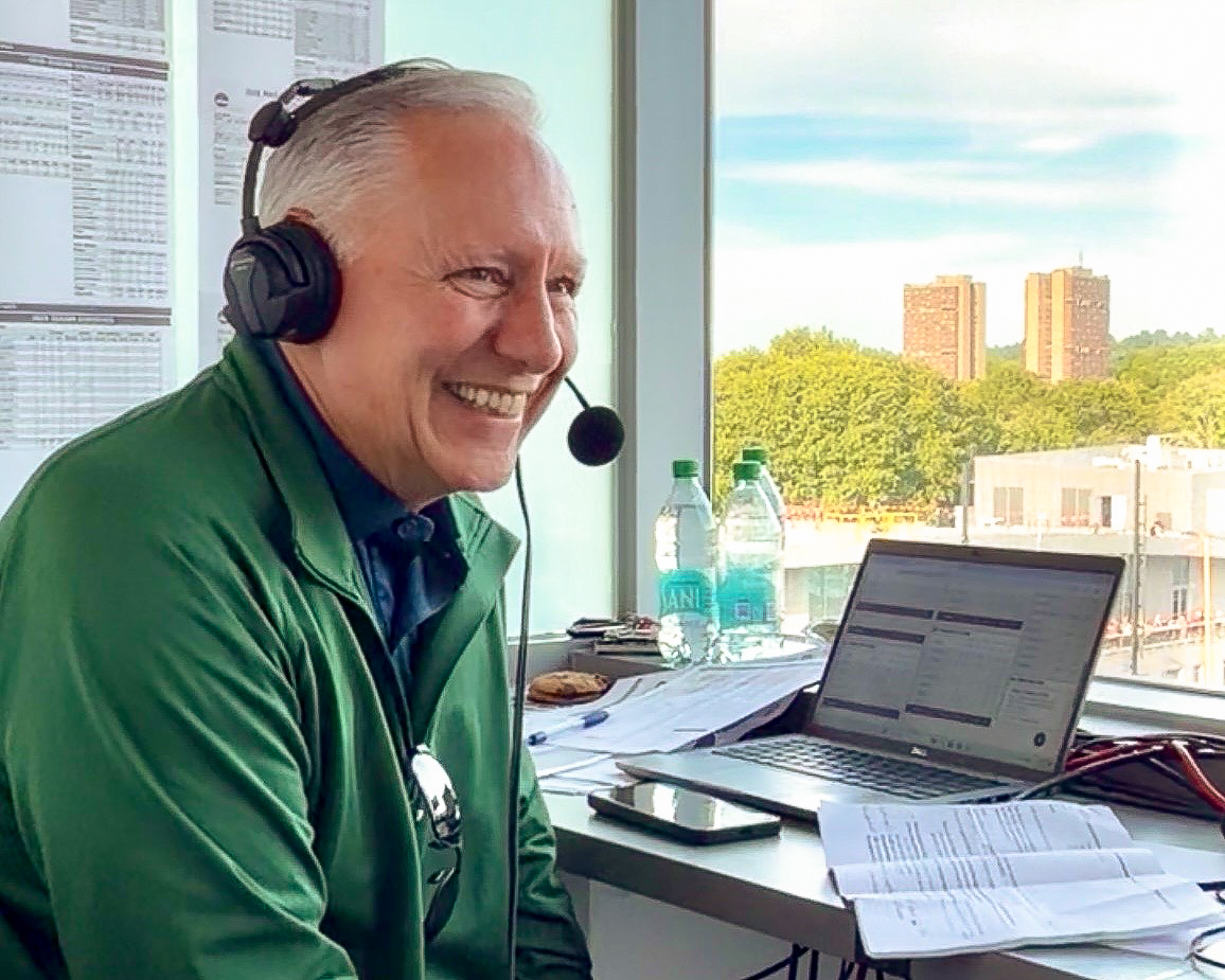 GSB President and CEO Peter Albero wearing a headset during a halftime interview at a UMass game at McGuirk Stadium.