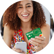 a woman holding a debit card and her mobile phone