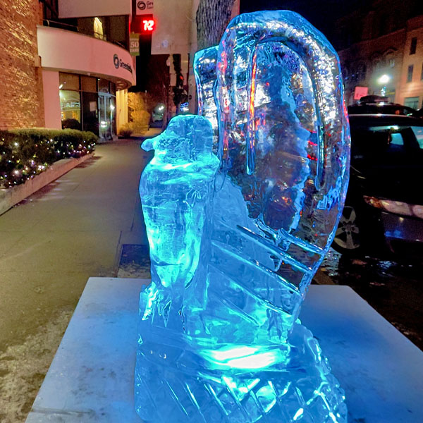 Photo of an ice sculpture of an eagle on the sidewalk in front of Greenfield Savings Bank on Main Street in Greenfield