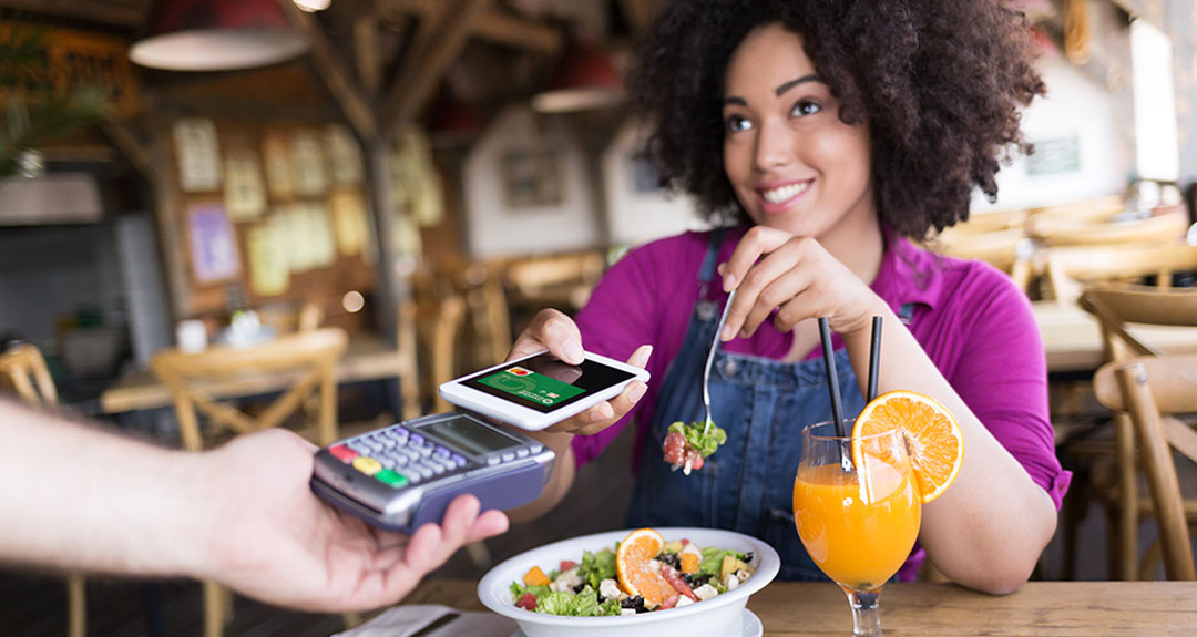 a lady using her mobile phone to make a purchase