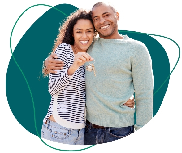 photo of a smiling couple, arm in arm, one of them is holding a house key