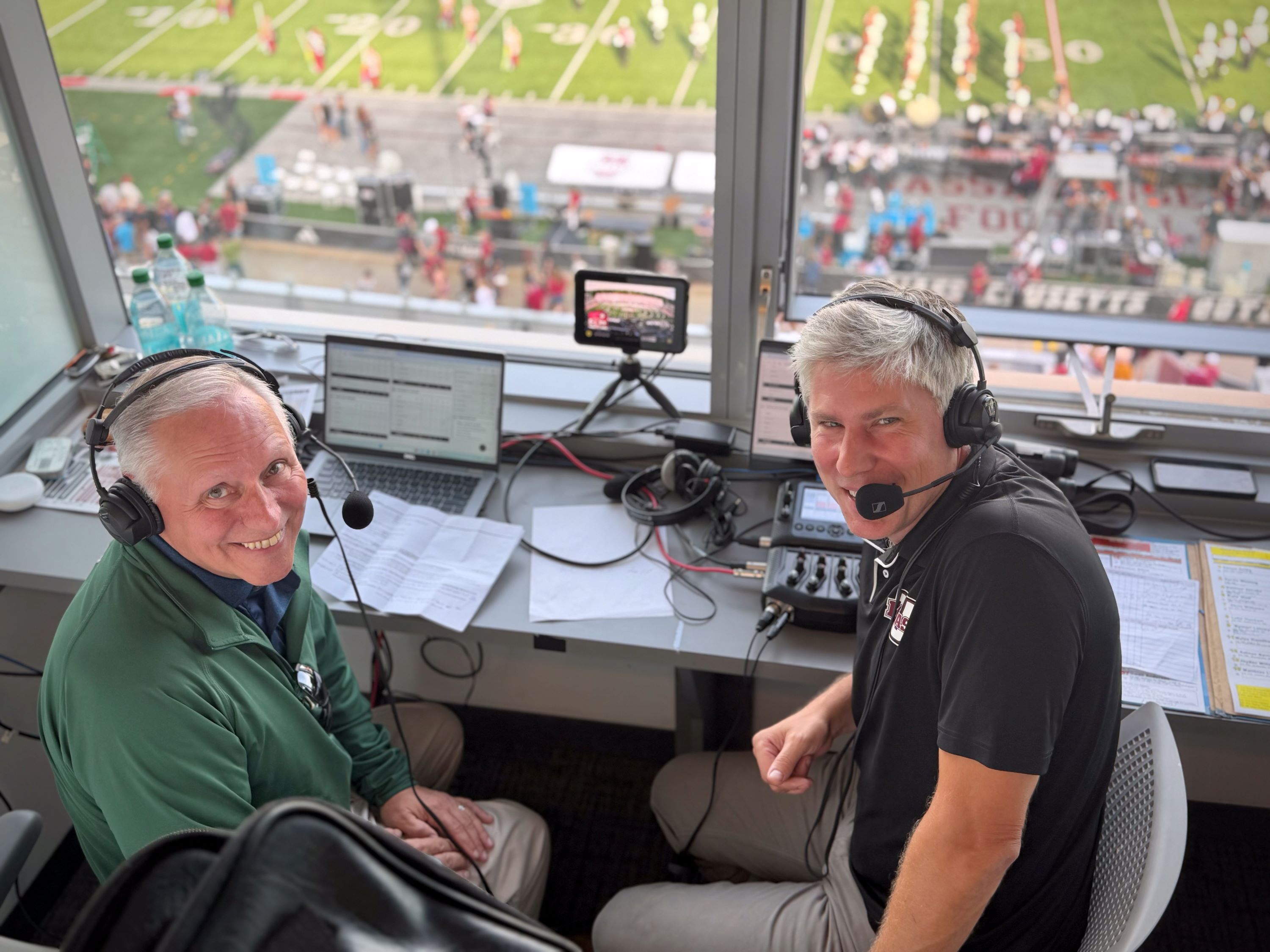 GSB President and CEO Peter Albero and UMass Minuteman broadcaster Jay Burnham in the press box at McGuirk Stadium.