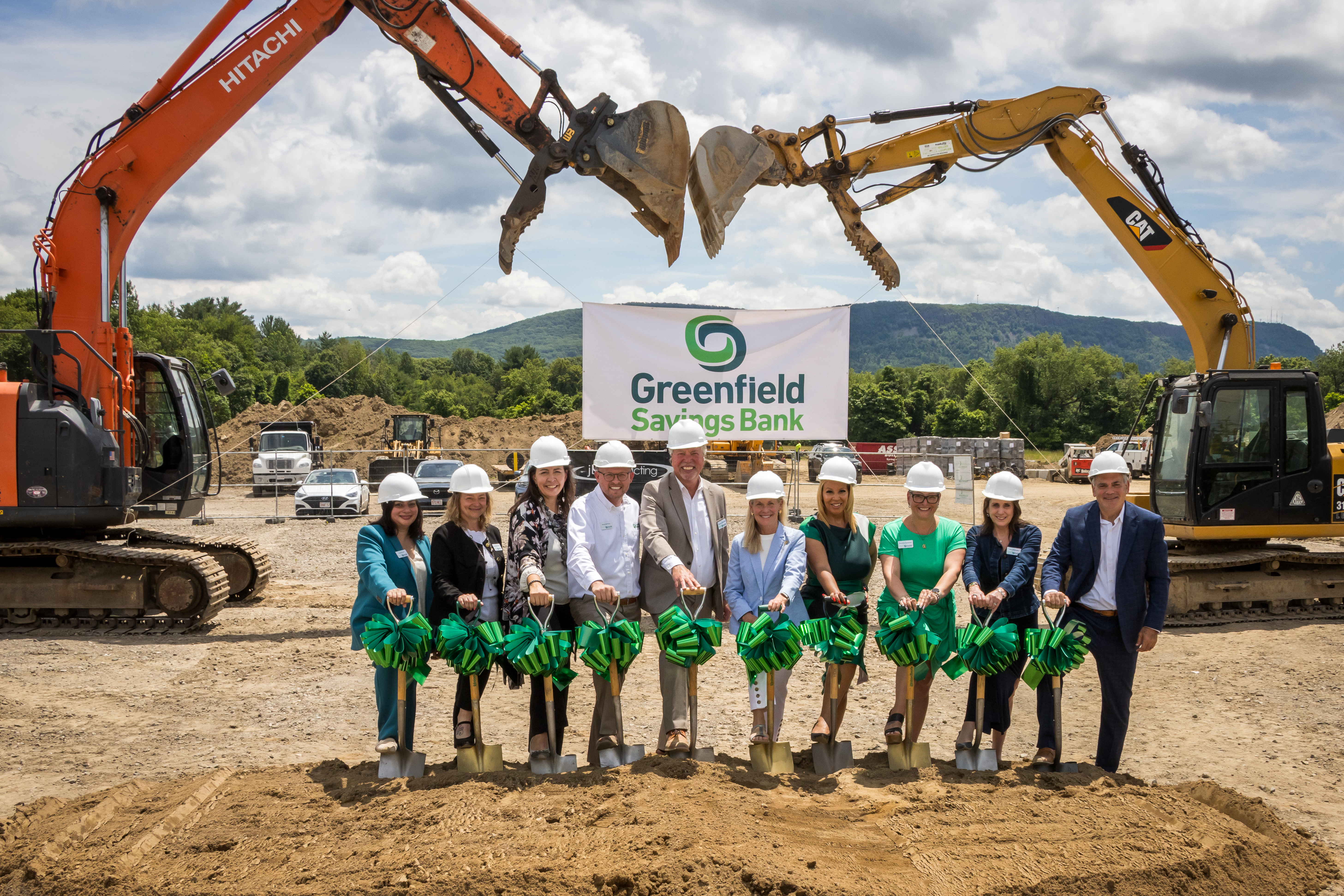 Members of Greenfield Savings Bank's executive staff hold ceremonial shovels at a groundbreaking ceremony