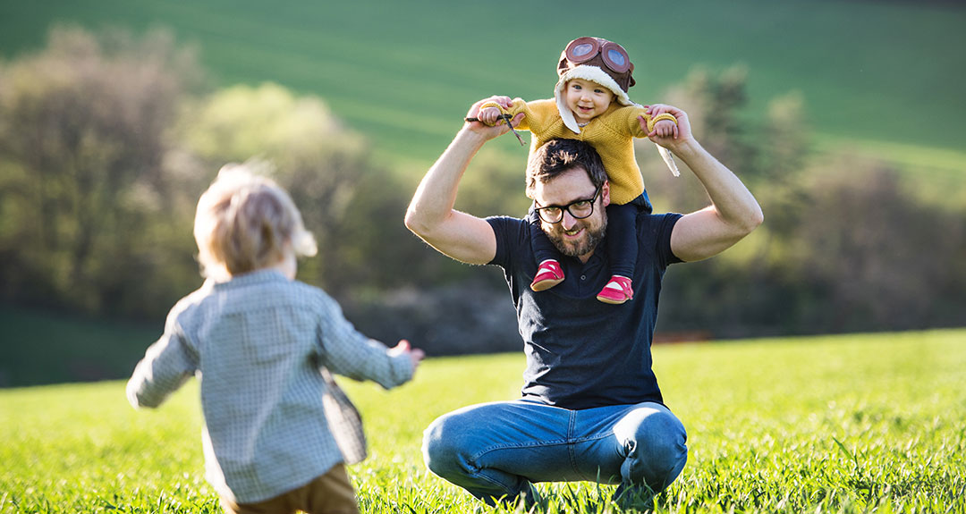 a father playing with his children