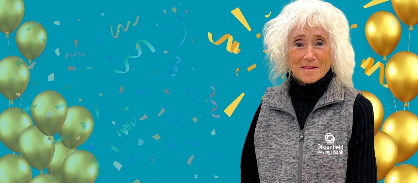 picture of Linda Ackerman with gold ballons and confetti behind her