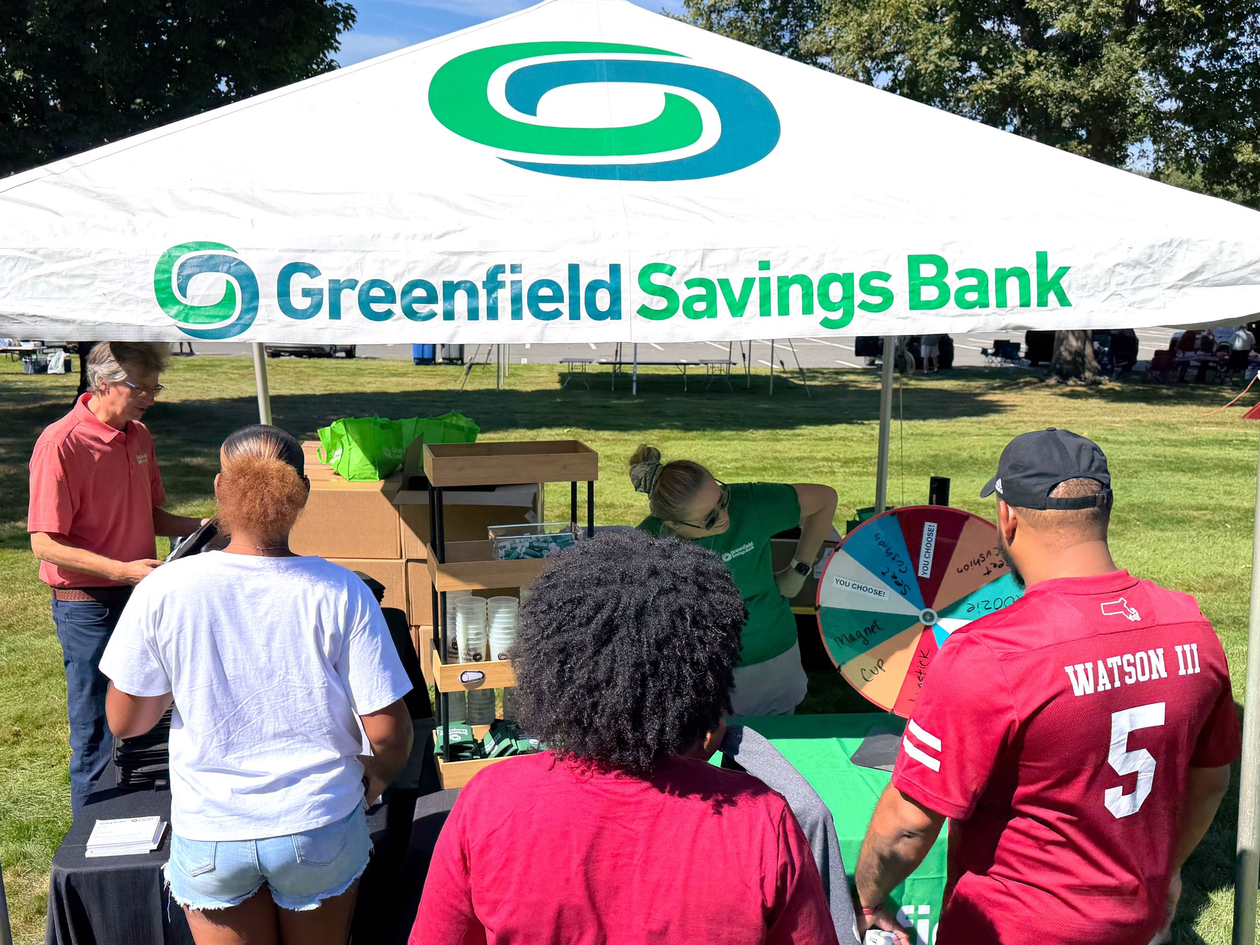 A person spins the prize wheel at the GSB tent before a UMass football game outside McGuirk Stadium.