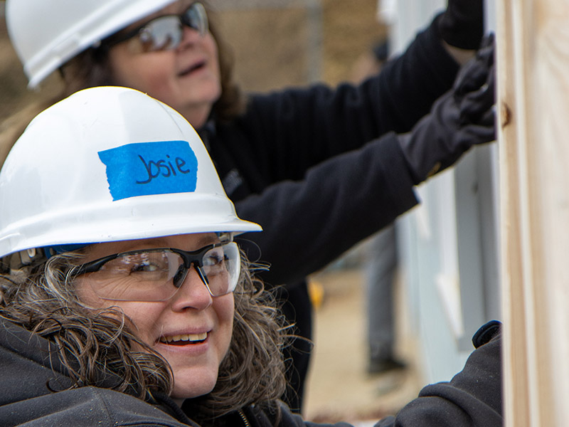 photo of Joesette Picard and Caryl Connor helping construct a Habitat for Humanity house