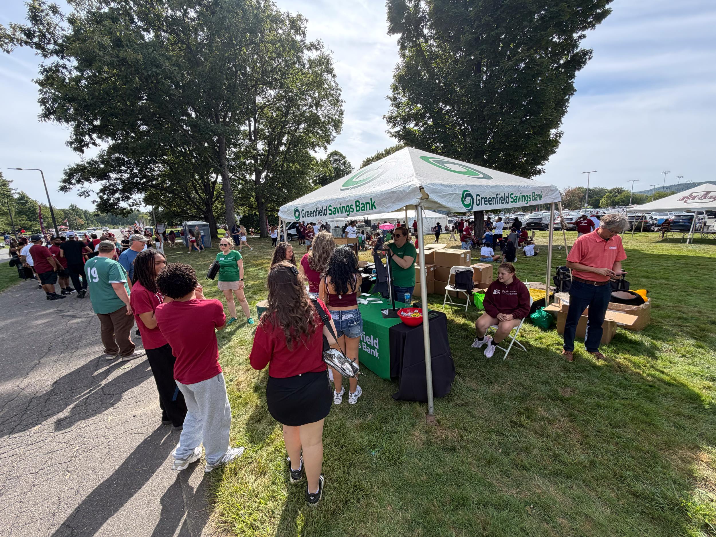 People gathered around the GSB tent before a UMass football game outside McGuirk Stadium.