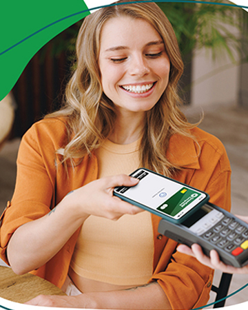 This is an image of a young blonde woman using her GSB card on her phone to pay for something.